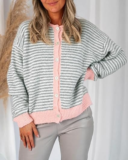 Light grey striped cardigan with pink trim worn with neutral pants