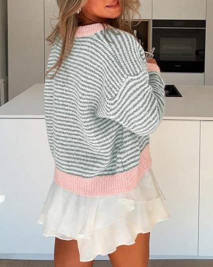 Back view of grey and white striped cardigan with pink trim